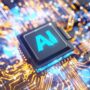 Close-up of a computer chip with AI text glowing in blue.